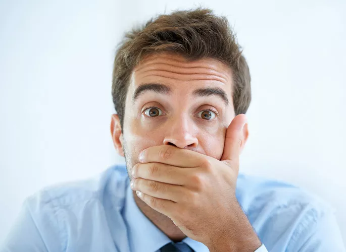 Man covering his mouth with hand